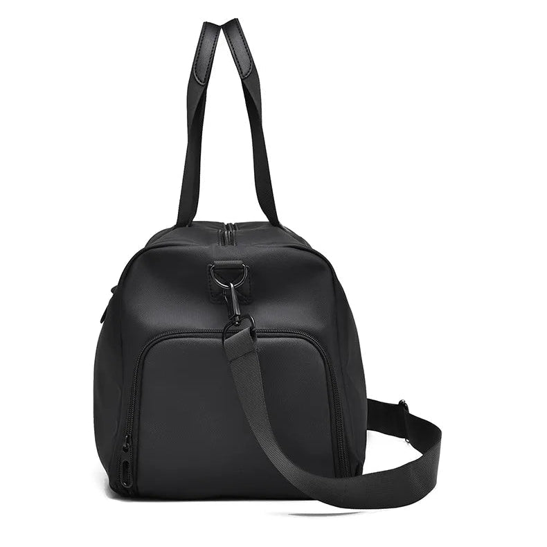 Black minimalist travel duffel bag with shoulder strap, side view for commuters and global travelers