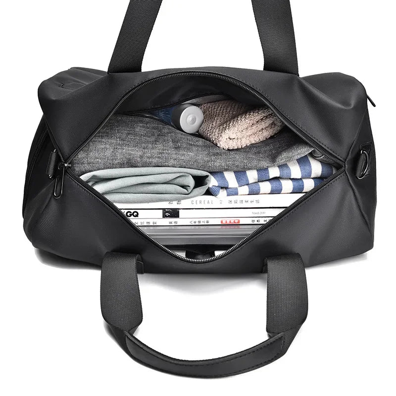 Black duffel bag with organized interior, holding clothes, magazines, and travel essentials for commuters and travelers